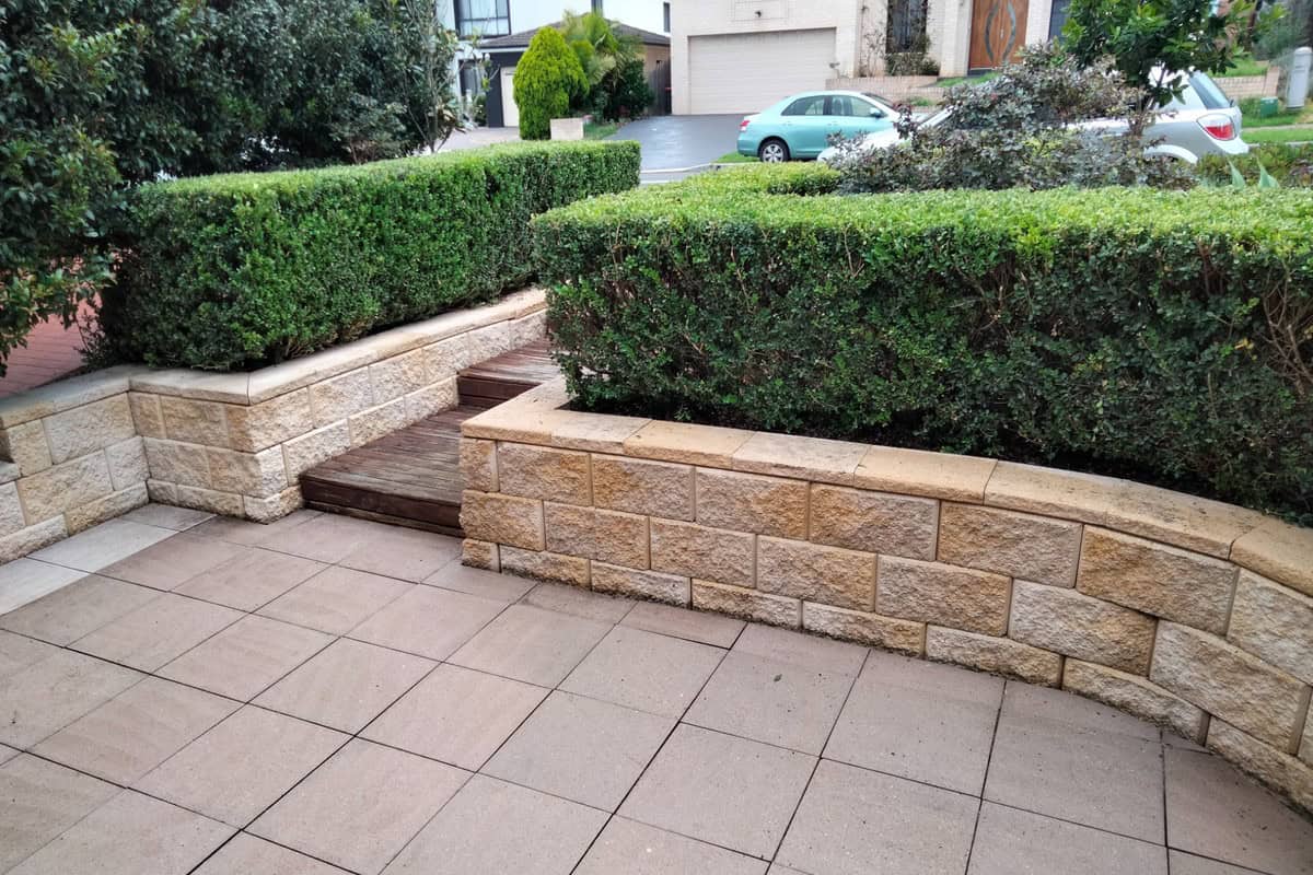Pavers and sandstone retaining wall after high pressure cleaning in Kellyville Ridge NSW