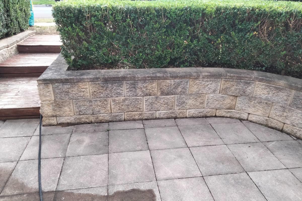 Pavers and sandstone retaining wall before high pressure cleaning in Kellyville Ridge NSW